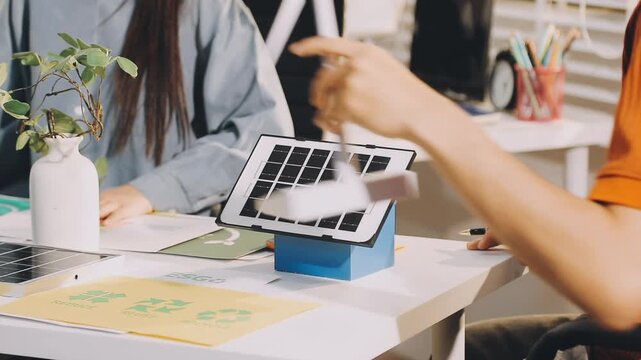 Business executives collaborating on environmental sustainability strategy utilizing renewable energy solutions to achieve net zero targets in corporate meeting.