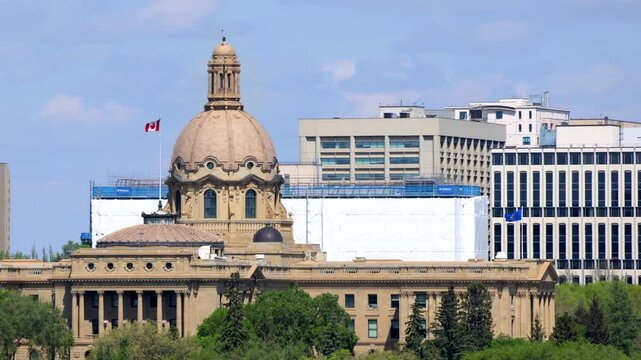 The historic Alberta Legislature Building dome with a Canadian flag flying in Edmonton, Alberta, Canada. 