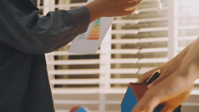 Business executives collaborating on environmental sustainability strategy utilizing renewable energy solutions to achieve net zero targets in corporate meeting.