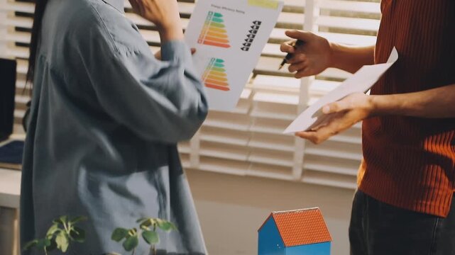 Business executives collaborating on environmental sustainability strategy utilizing renewable energy solutions to achieve net zero targets in corporate meeting.