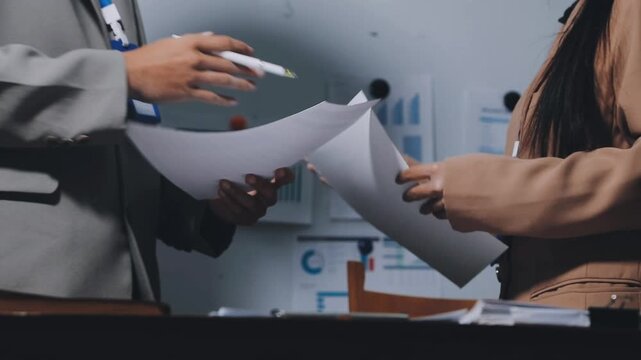 Asian business adviser meeting to analyze and discuss the situation on the financial report in the meeting room.Investment Consultant, Financial advisor and accounting concept