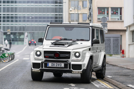 Nancy, France - January 4th 2021 : View on a white Mercedes-Benz Brabus G 700 Widestar driving on a street. It's a Mercedes G-Class modified by Brabus.