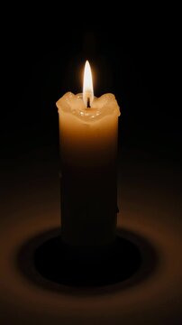 Single candle flame burns calmly in dark space creating a peaceful spiritual background for remembrance meditation hope and warm minimalist designcandle