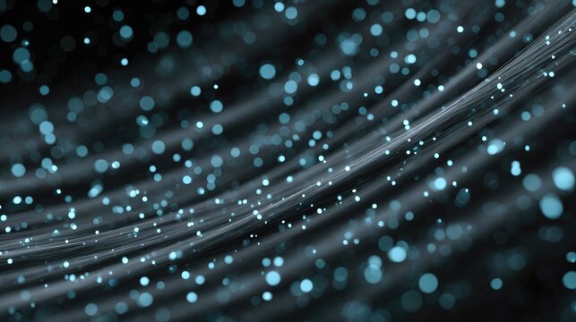 Abstract background of flowing particles and soft waves in shades of blue and black with a mesmerizing bokeh effect