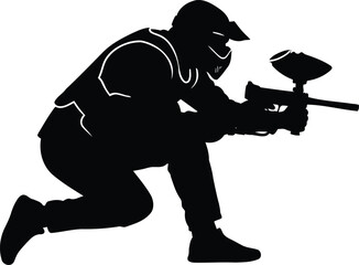 Black silhouette of a paintball player in protective gear crouching with a marker gun ready to shoot © saju
