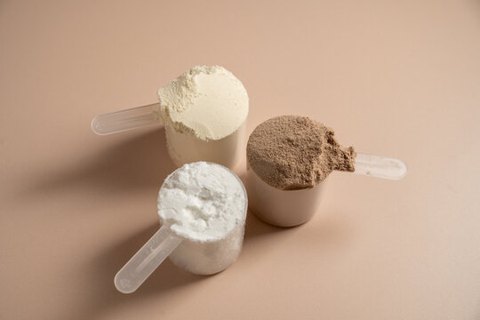Collagen, creatin or protein powder in scoops. Food supplement, fitness sport, health and nutrition.