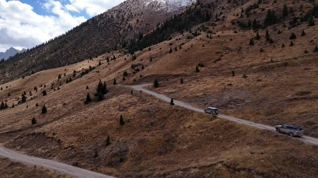 SUV Convoy On Mountain Road In Tien Shan Kyrgyzstan Drone View