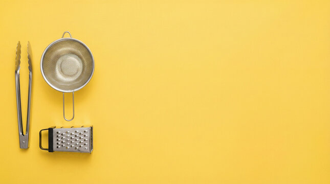 Kitchen utensils on yellow background, cooking tools, chef essentials