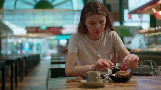 Tourist woman eating Singaporean breakfast at Lau Pa Sat. Travel and tourism in Asia, street food at markets.