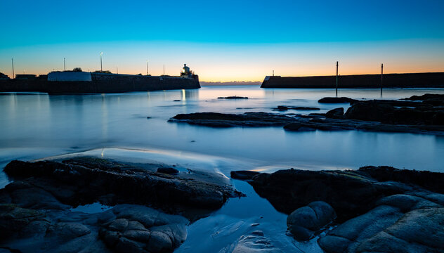 Arbroath Harbour Scotland sea wall watch house and signal house water rocks early morning long exposure beach