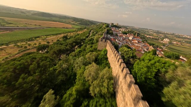 FPV drone flying along castle walls in &Oacute;bidos Portugal with view of medieval village and historic architecture.
4K high quality cinematic FPV footage.