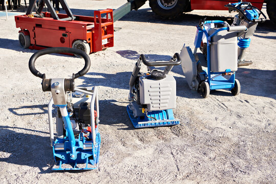 Plate compactors and construction equipment on outdoor site