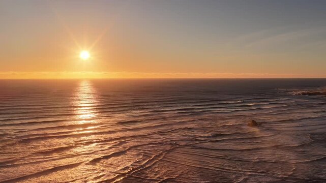 Zoom in to setting sun over ocean horizon at delta of Arthur river West coast in Tasmania.