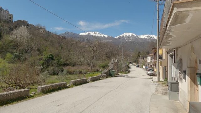 Panoramic view of the Italian village Castel San Vincenzo with snow-capped mountains