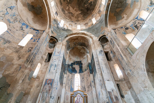 Interior view of Akdamar Church in Lake Van, T&uuml;rkiye, featuring medieval frescoes, apse structure and historic religious architecture under natural light.