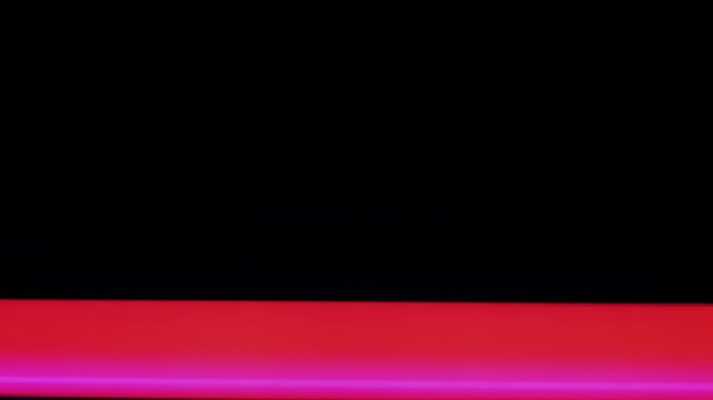 Abstract red and blue neon light bars scroll vertically across a black screen. This creates a digital glitch or futuristic transition effect with vibrant, glowing colors.