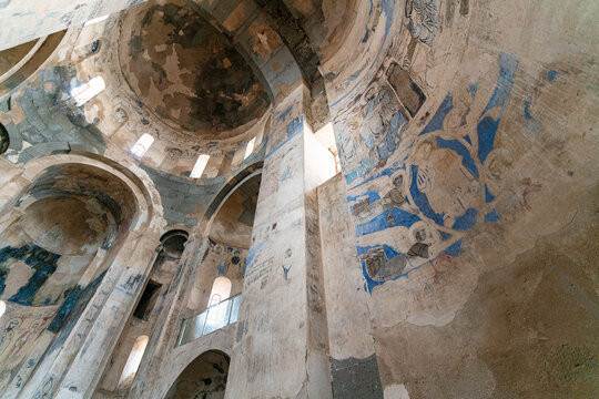 Interior view of Akdamar Church in Lake Van, T&uuml;rkiye, featuring medieval frescoes, apse structure and historic religious architecture under natural light.