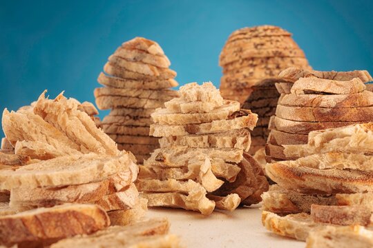In a playful landscape, sliced bread forms surreal, towering peaks reminiscent of a canyon. This delightful scene captures the imagination with warm tones and an inviting atmosphere