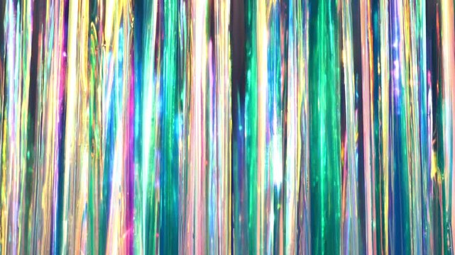 Iridescent holographic tinsel creating a vibrant abstract rainbow background