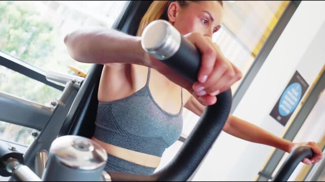 Woman Exercising on Pec Deck Machine in Gym