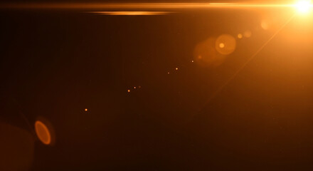 Warm orange light shining through a dark space with lens flares and a bright sunbeam in the corner