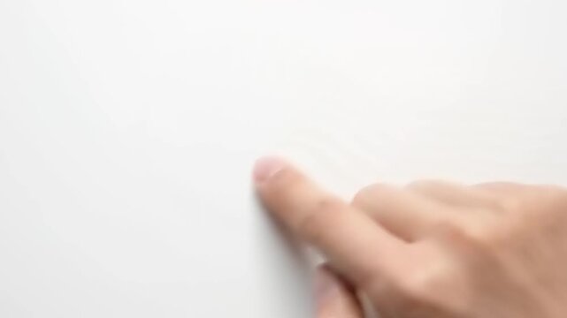 Hand pointing to blank white surface.
