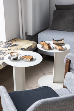 Coffee and homemade cake on table in cozy cafe interior, minimal lifestyle scene