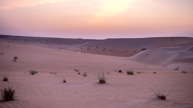 Sunset-sunrise time lapse over emptied desert sand dune. Vibrant sky transitions, golden light on sand dunes