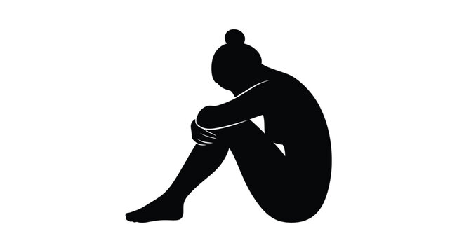 Abstract black silhouette of a person sitting curled up and hugging their knees in deep thought.