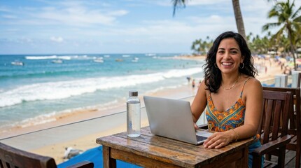 Fototapeta premium the 31-year-old latina woman is framed boldly at her small table, with her laptop and water bottle prominently placed, set against a backdrop of waves and sandy beach