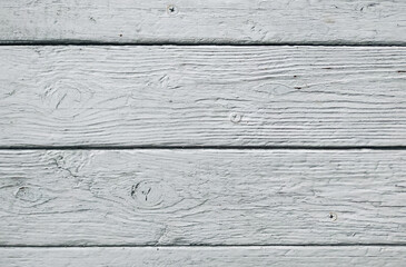 Old white cracked paint on top of a wooden table. Texture and grunge background.