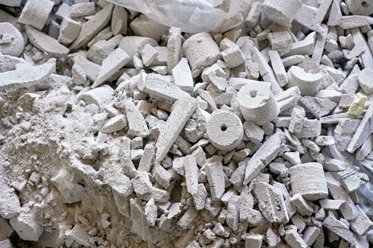 Construction site waste debris - remains of white aac - autoclaved aerated concrete brick blocks, closeup detail