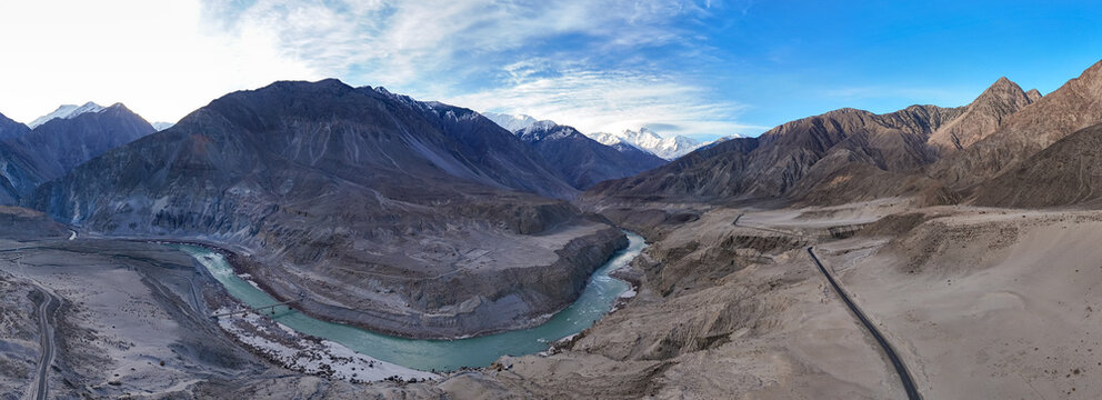 A Cinematic High-Altitude View of Jaglot and the Karakoram Highway, Aerial panorama of the Winding Indus River and Ancient Silk Road