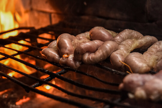 Cow bowels presented on a wooden board with ingredients, ready to grill