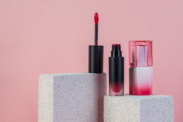 Mock up of black blank thin tube - mascara, lip gloss, gel, eyeliner, oil, etc. Cosmetic package with stylish props on pink background.  © apinya