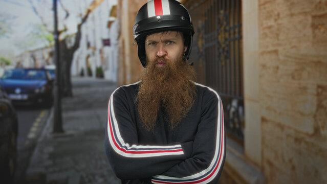 Man with black motorcycle helmet and arms crossed on street beside a stone building; denial rejection.