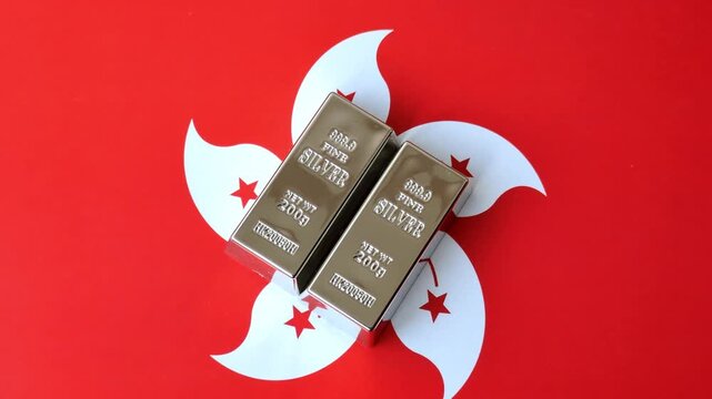 A silver bar, white metal against a backdrop of hong kong flag, as a concept for the sales market. A silver bar as a background for your design