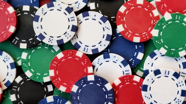 Multicolored casino chips as a conceptual backdrop for gambling games like poker, blackjack, or baccarat. Multicolored casino chips as a backdrop for your design