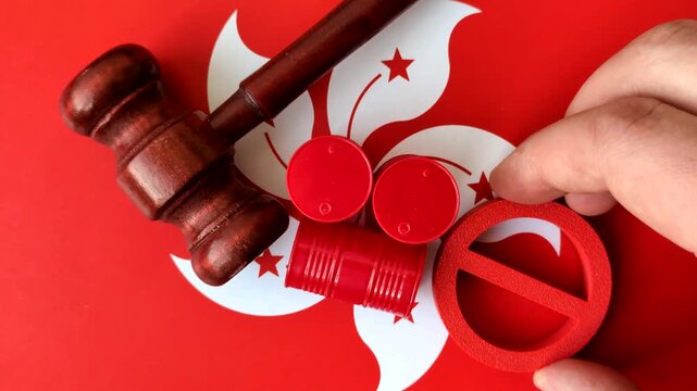 Metal barrels of oil, gas, or chemicals bearing on the flag of hong kong and a ban sign, embargo on production. Barrels of hong kong oil