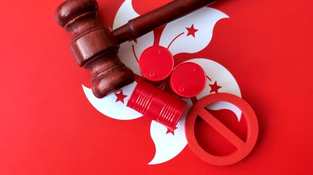 Metal barrels of oil, gas, or chemicals bearing on the flag of hong kong and a ban sign, embargo on production. Barrels of hong kong oil