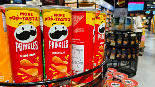 Pringles Original potato chips red cans stacked on a circular retail display shelf in a modern supermarket grocery store on September 17, 2025 in Bangkok, Thailand.
