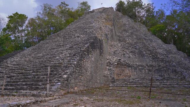 Ancient ruins of Mayan pyramids at the archaeological site of Coba on the Yucatan Peninsula, Mexico. Majestic stone structures surrounded by jungle nature. History, culture and travel exploration