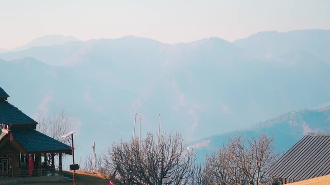 Landscape shot of foggy Himalayan mountain range during the summer season as seen near Hadimba Devi Temple in Thachi village at Kullu district, Himachal Pradesh, India. Natural background.