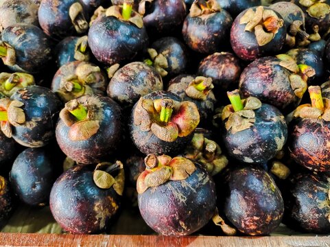 Close-up and top-view of mangosteen fruit Garcinia mangostana