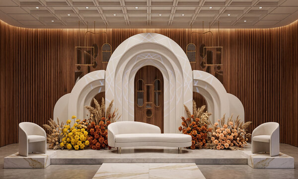 Elegant modern event stage decoration with white arched backdrop, lounge furniture, and warm floral arrangements