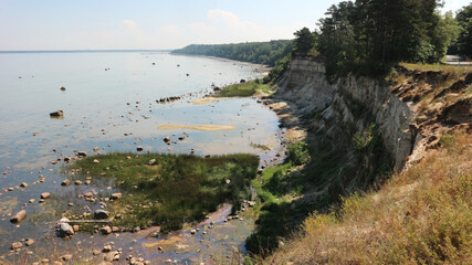 Obraz premium Eroded Coastal Cliffs and Rocky Shoreline Landscape