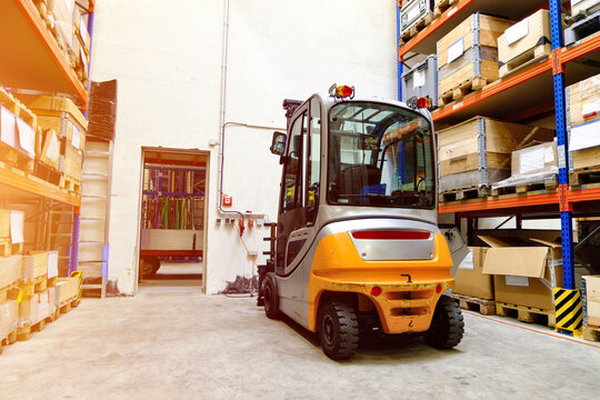 Forklift Truck in Modern Warehouse Storage Facility with Industrial Shelving
