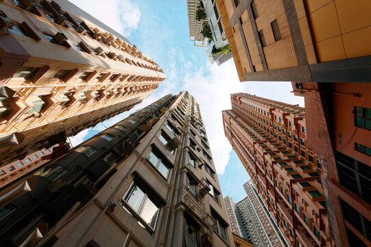Low angle view of high-rise residential towers with crowded narrow apartments in a community near Central-Mid-Levels Escalator & Walkway system in Hong Kong, a phenomenon of severe housing shortage