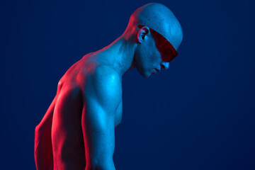 Man with sunglasses in vibrant blue and red lighting, creating a striking contrast and showcasing a...