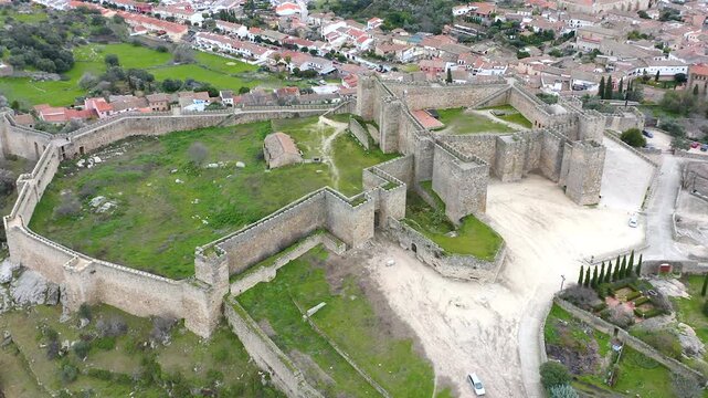 Aerial view of Trujillo Castle ruins in Caceres, Spain. Historic hilltop fortress remains open to visitors, medieval stone structures overlooking Castilla La Mancha landscape.